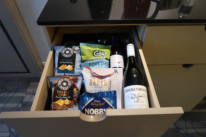 a drawer with food and wine bottles