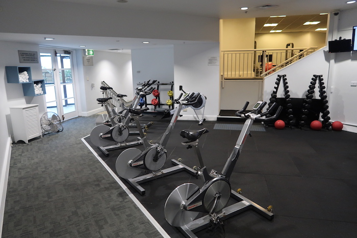a group of exercise bikes in a gym