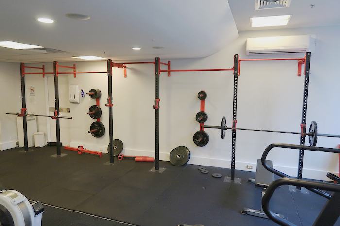 a gym with weights on the wall