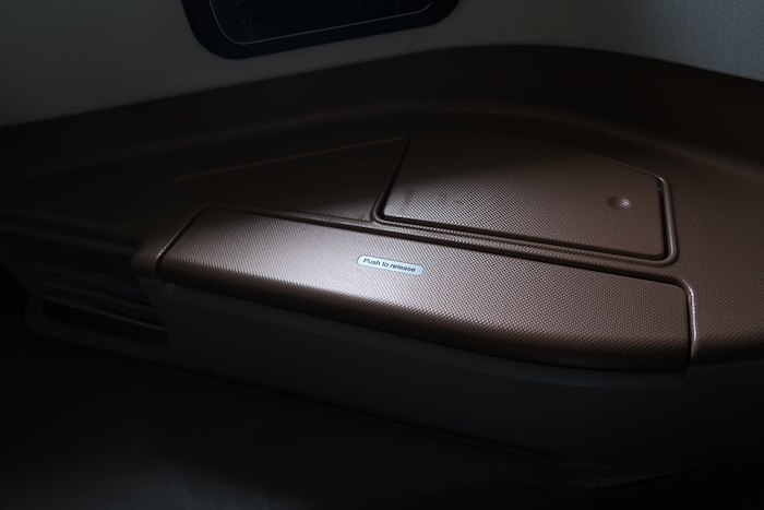a brown plastic seat with a label on it