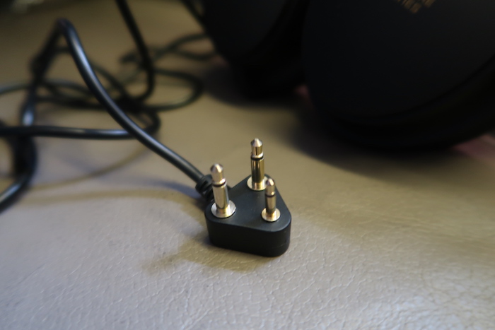 a black plug with gold colored plugs