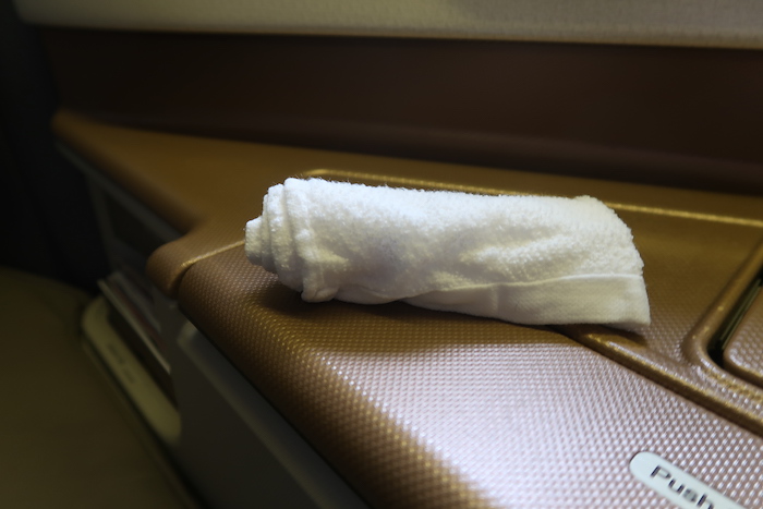 a white towel on a brown surface
