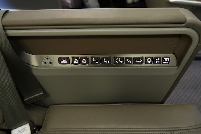 a seat with buttons and symbols on it
