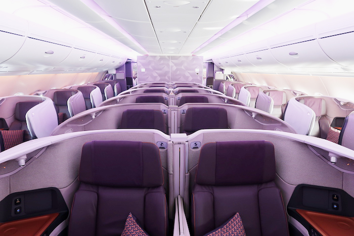 the inside of an airplane with purple seats