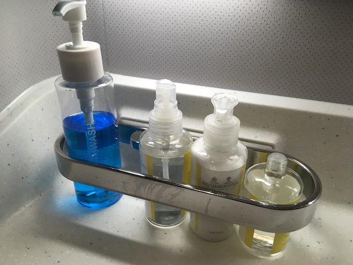 a group of bottles of liquid in a metal tray