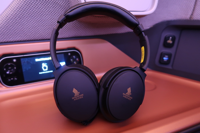 a pair of black headphones on a brown surface