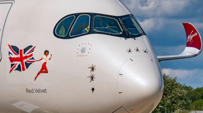 the nose of a plane with a woman on it