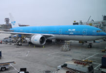 a blue airplane on a tarmac