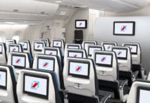 a row of seats with monitors on the side
