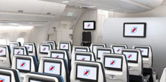 a row of seats with monitors on the side