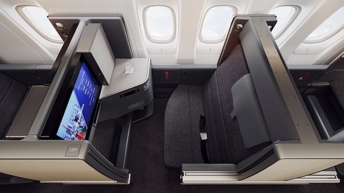 an airplane seat with a screen and a television