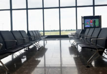 a row of chairs in a room with large windows