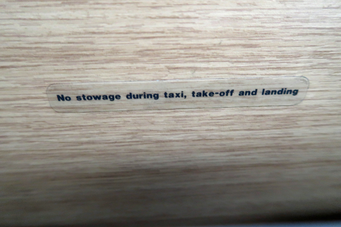 a sign on a wood surface
