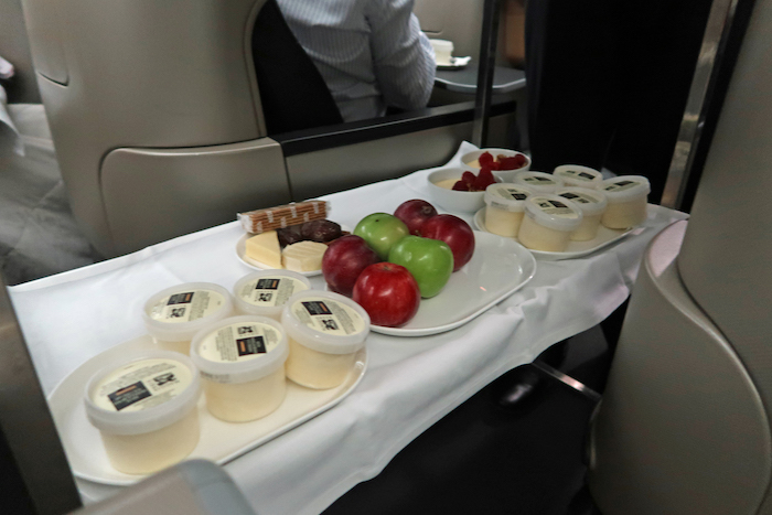 a tray of fruit and cheese on a table