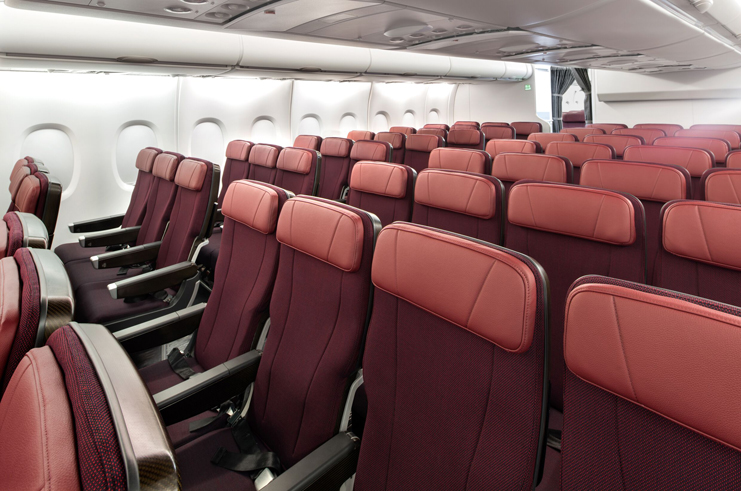 rows of red seats in an airplane