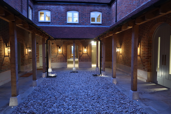 a brick building with a stone walkway