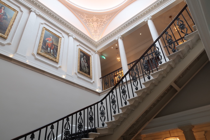 a staircase with art on the wall