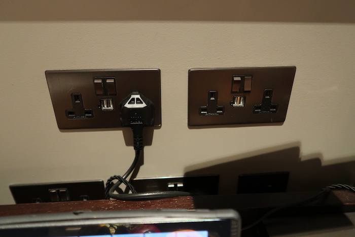 a wall outlet with plugs and cords