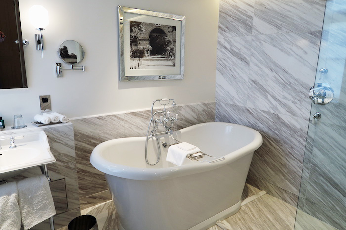 a bathroom with a tub and a mirror