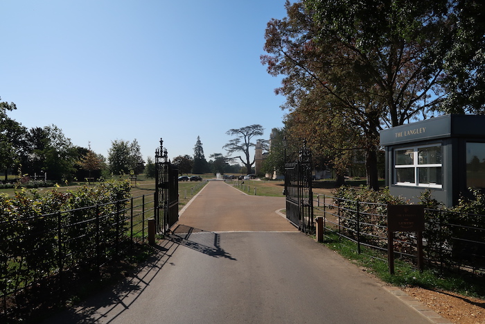 a road with a gate and trees