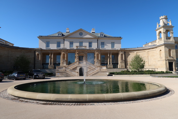 a large building with a fountain in front of it