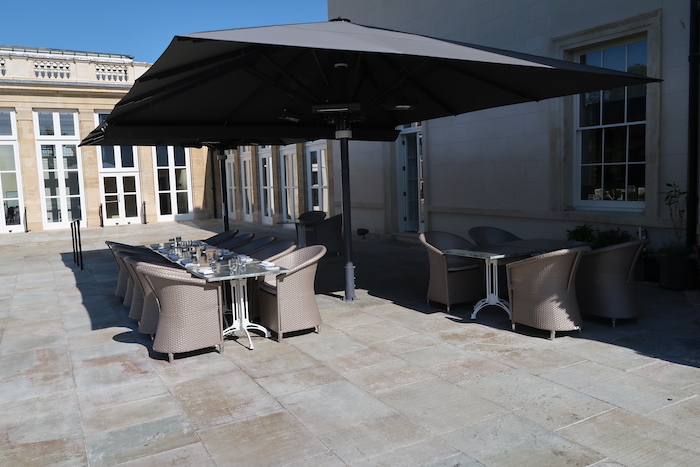 a table and chairs under a umbrella