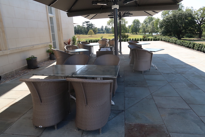 a patio with tables and chairs