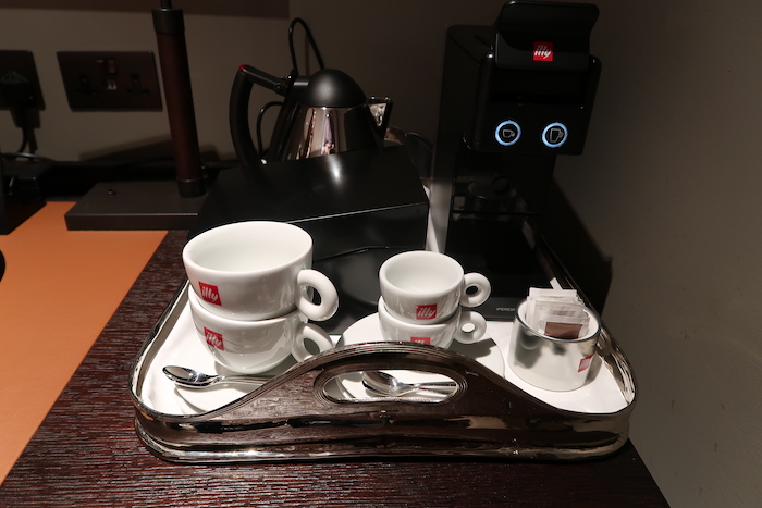 a tray with coffee cups and tea bags on it