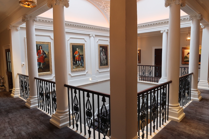 a staircase with art on the wall