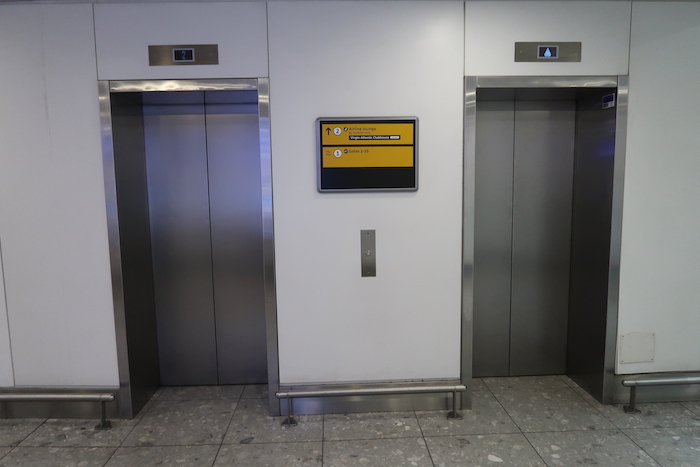 two elevators with a sign on the wall