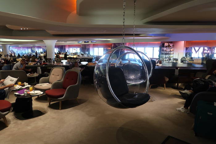 a room with a round chair from the ceiling
