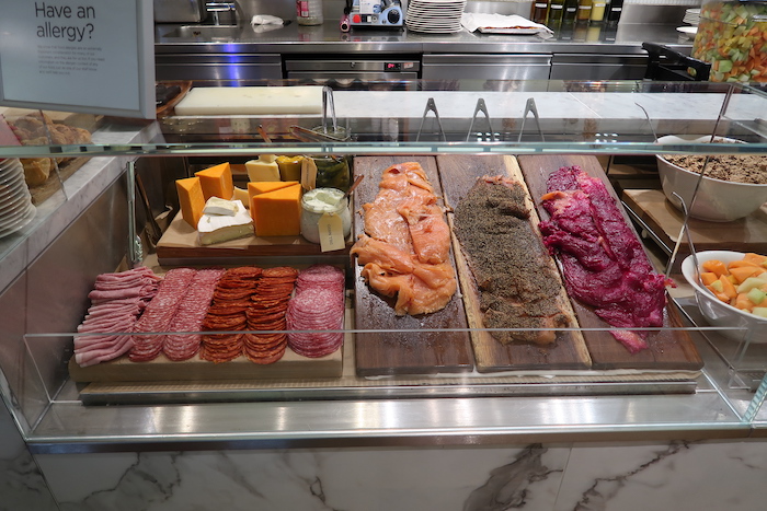 a display case with different types of meats and cheeses