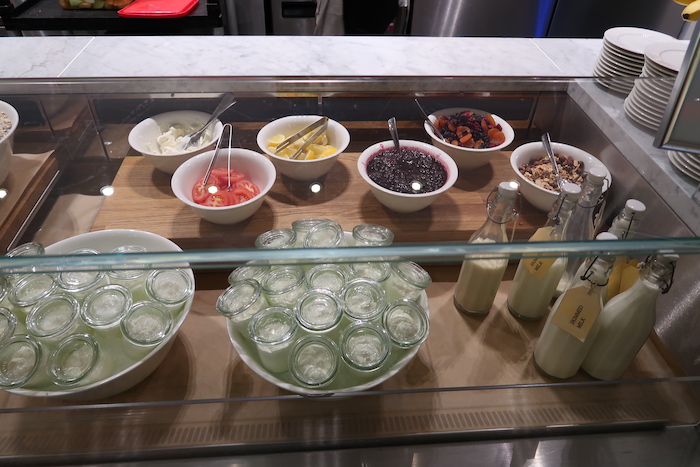 a glass case with bowls of food and bottles