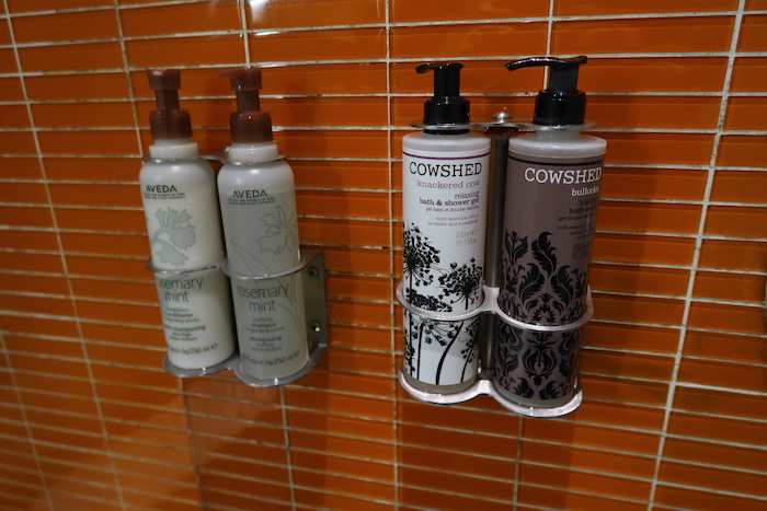 a group of bottles of shampoo and conditioner on a wall