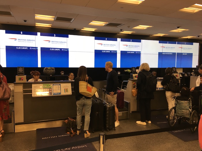 people standing in front of a large screen