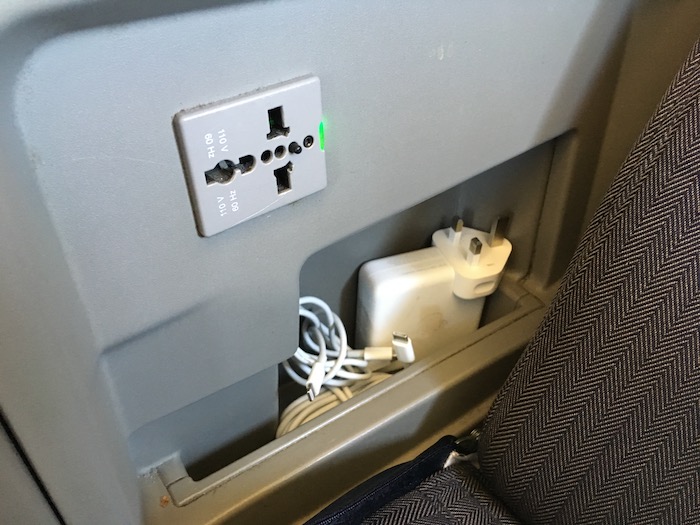 a power outlet and cords in a seat