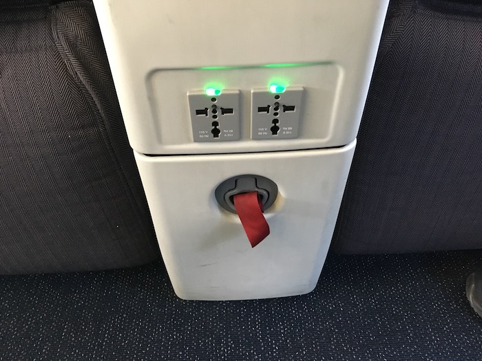 a white rectangular object with a red switch and green light