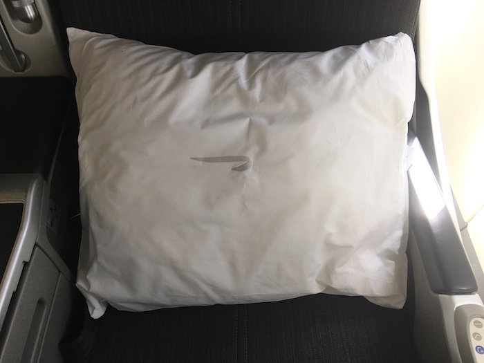 a white pillow on a chair