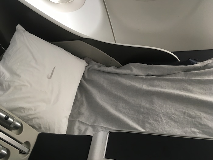 a pillow and a bed in an airplane