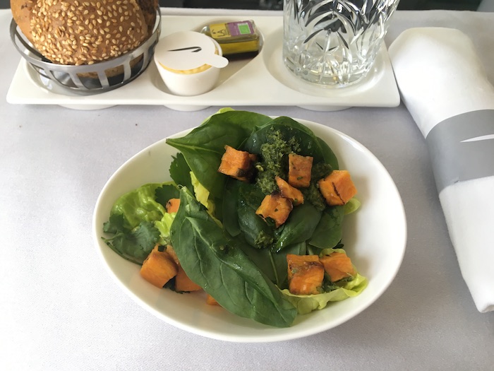 a bowl of salad with food on it