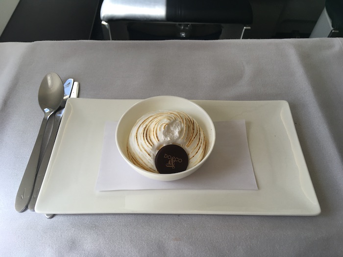 a bowl of ice cream with a cookie on a plate