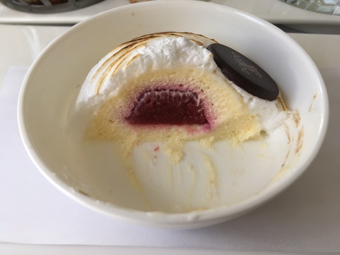 a bowl of ice cream with a red jelly inside