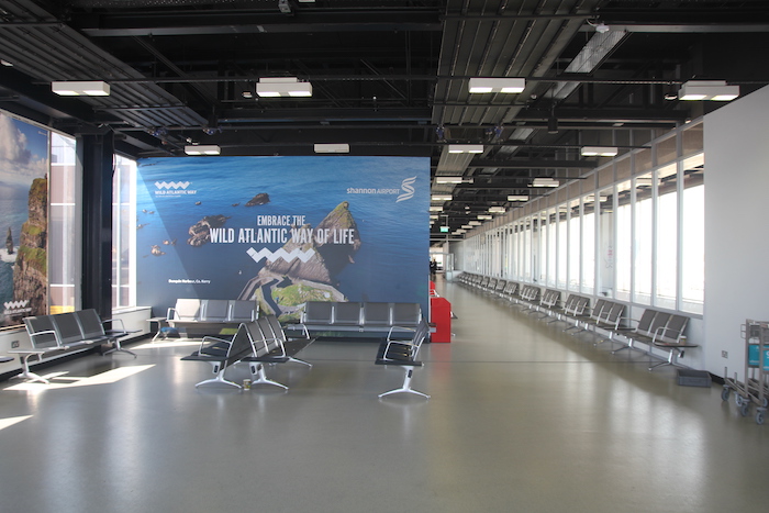 a large room with chairs and a large sign