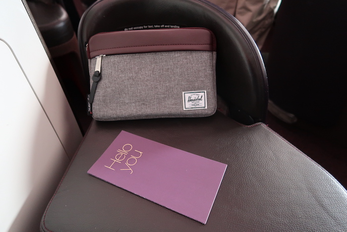 a purple card and a purse on a chair
