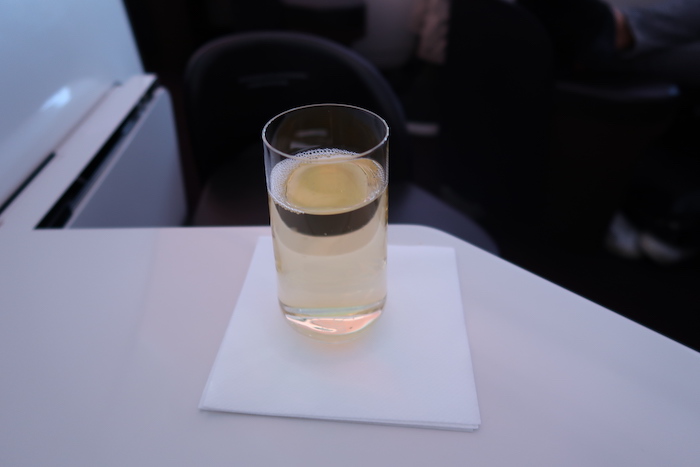 a glass of liquid on a white napkin