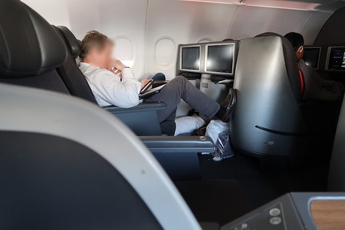 a man sitting in a chair with a laptop