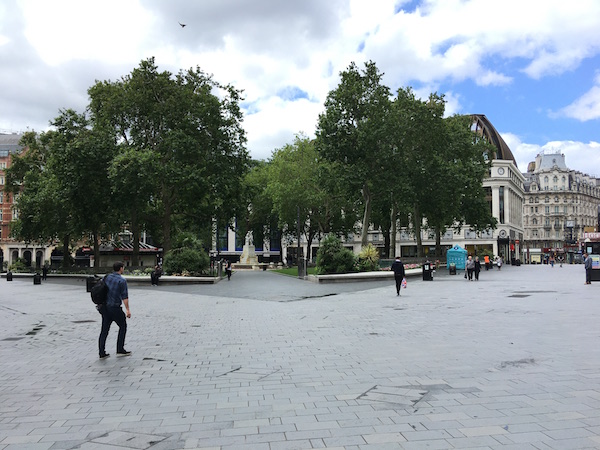 people walking in a plaza
