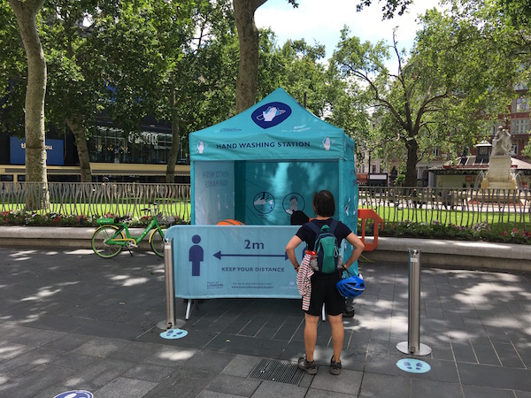a person standing in front of a blue tent