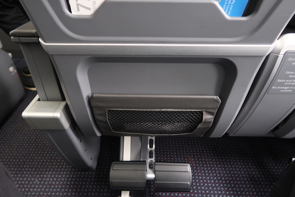 a seat with a pedal and a paper holder