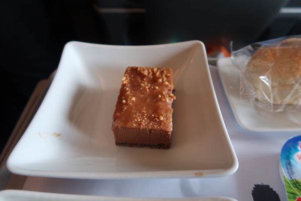 a rectangular white plate with a brown dessert on it